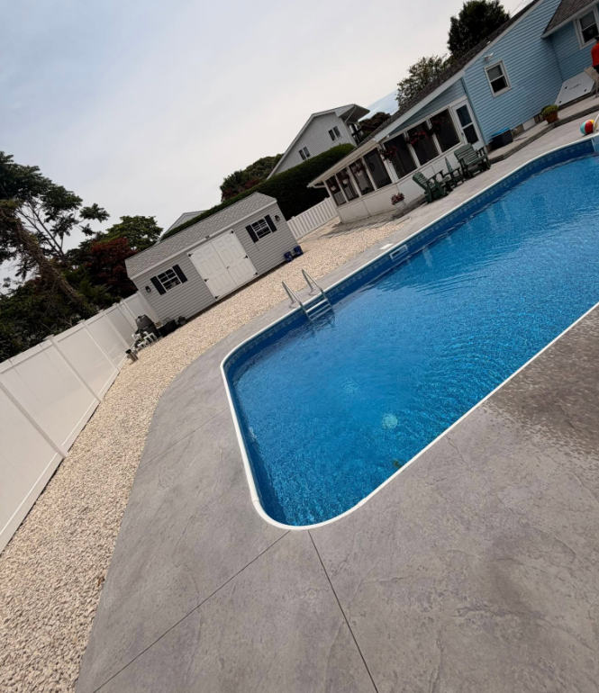 Finished stamped concrete pool deck with decorative stone border