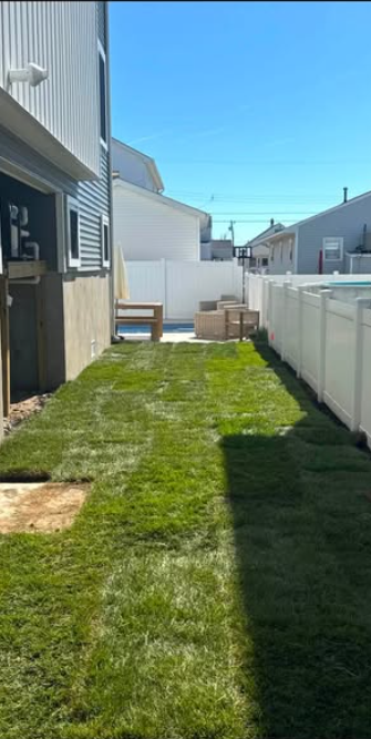 Finished green sod lawn in a side yard between two homes